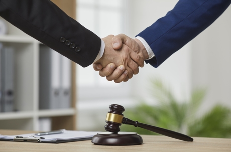 Two lawyers shaking hands